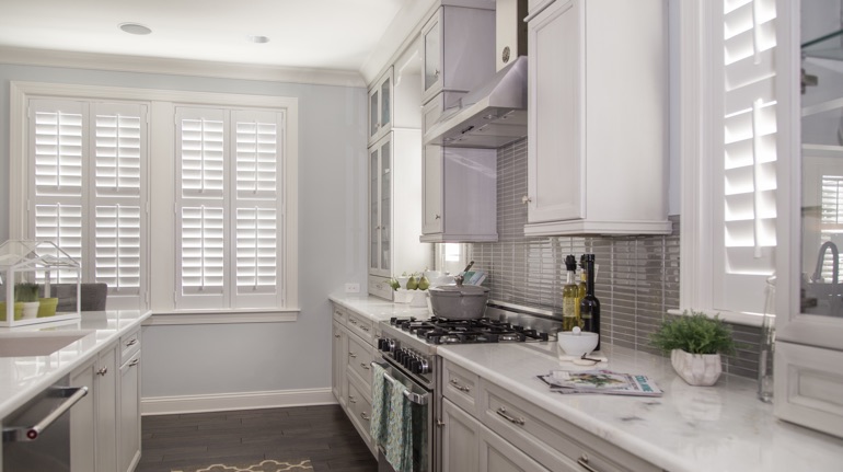 Plantation shutters in Austin kitchen with white cabinets.